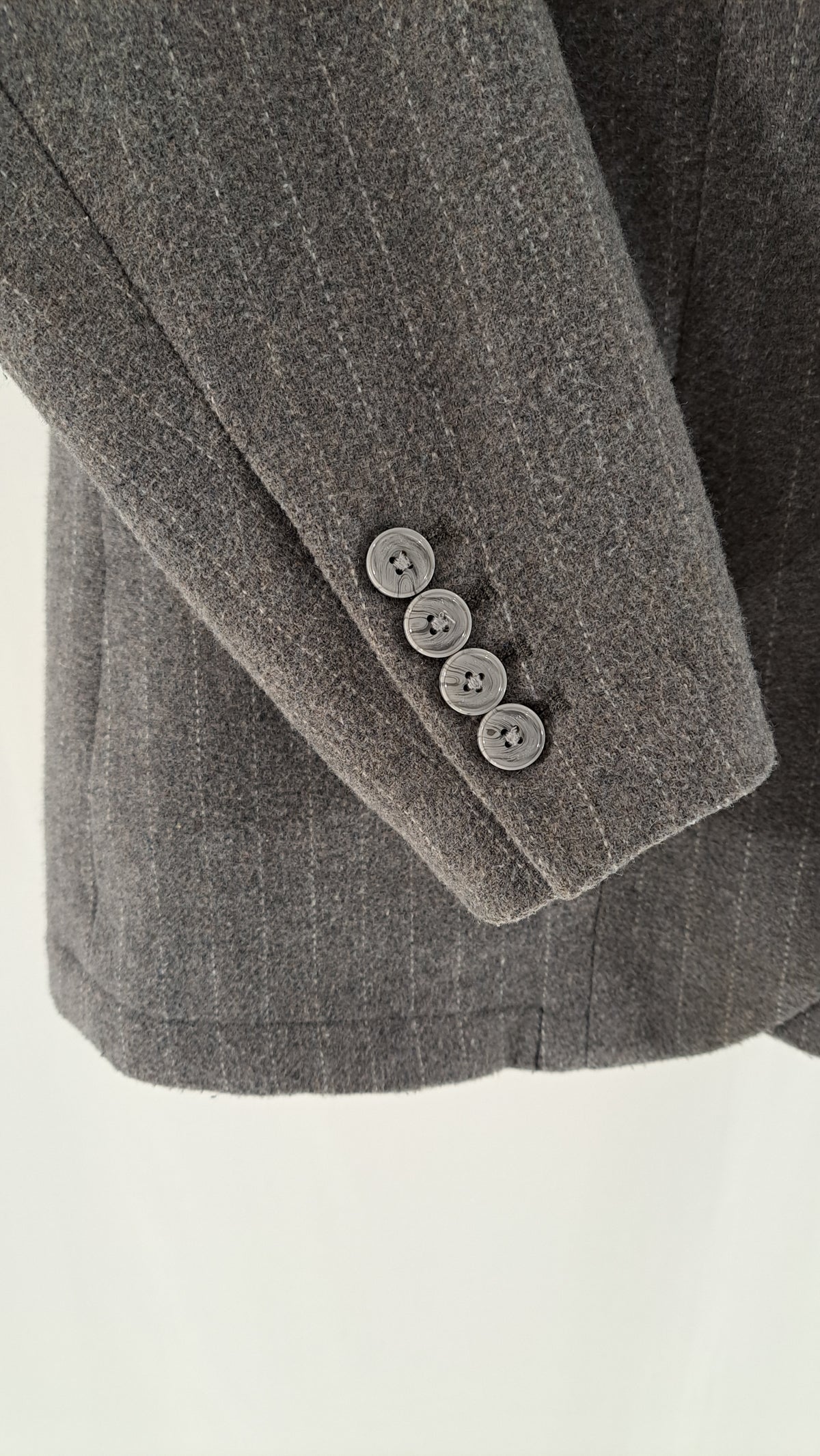 Nærbillede af knapper på ærme af gråmeleret Armani blazer