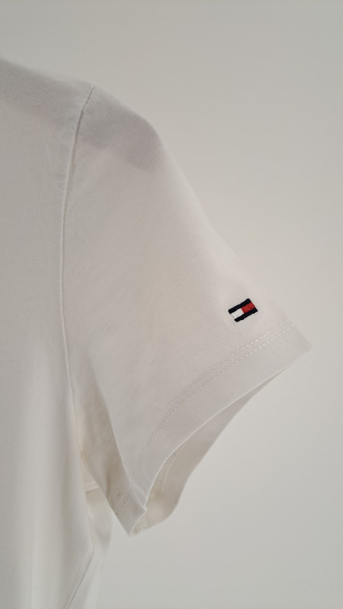 Nærbillede af ærme med broderet Tommy Hilfiger flaglogo